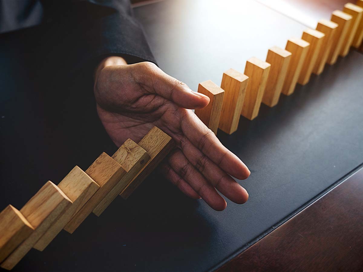 hand in the middle of a domino set