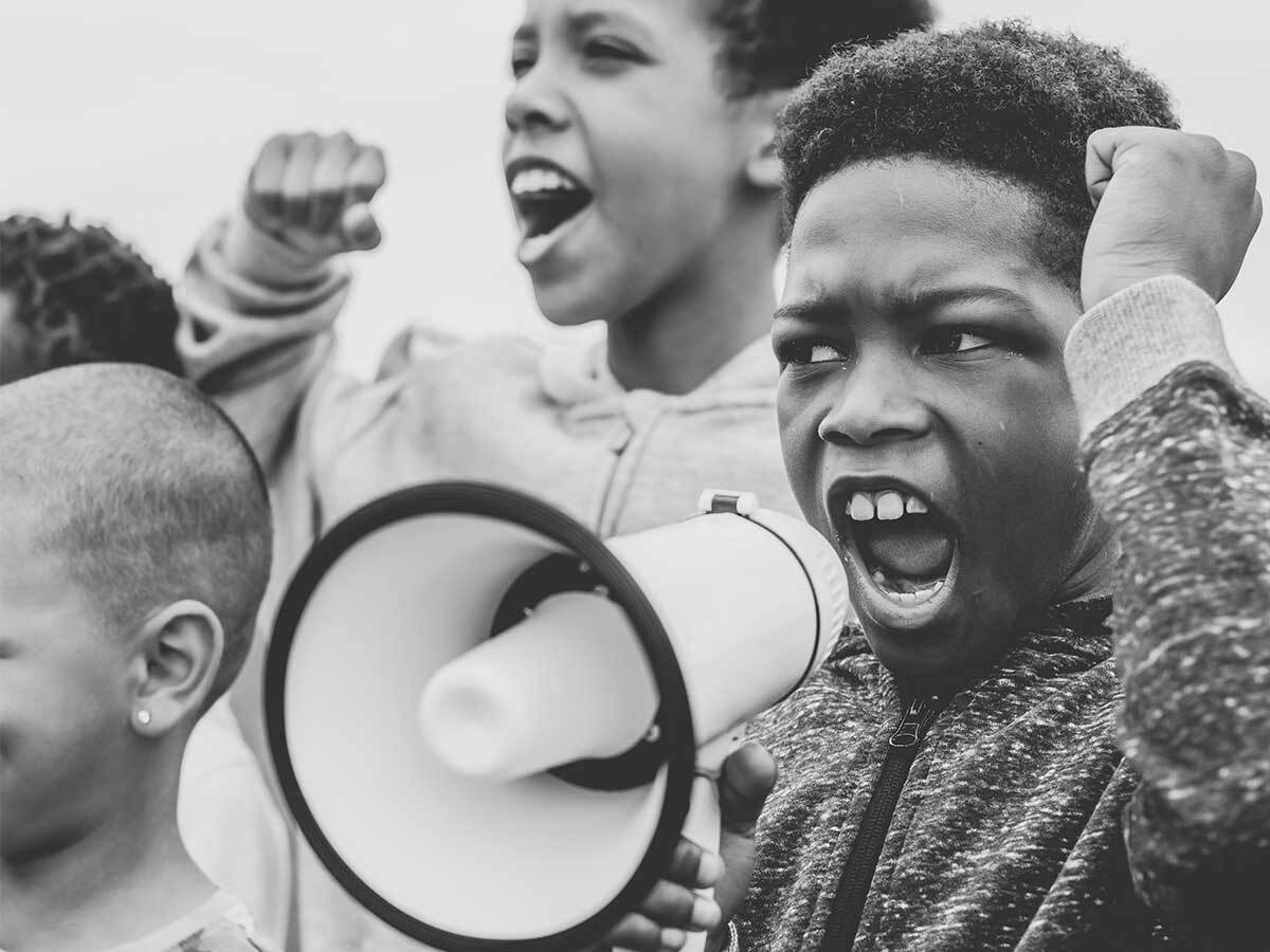 young boy protesting with megaphone