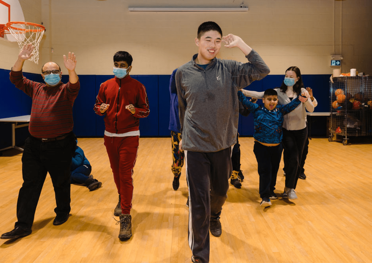 Group of dance students smiling and walking forward