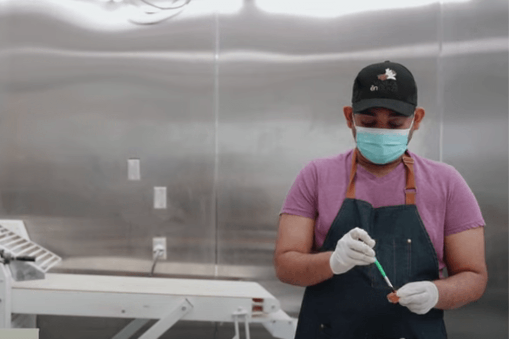 Goodness Gift graduate works on Vanilla En Glaze's kitch in preparing baked goods