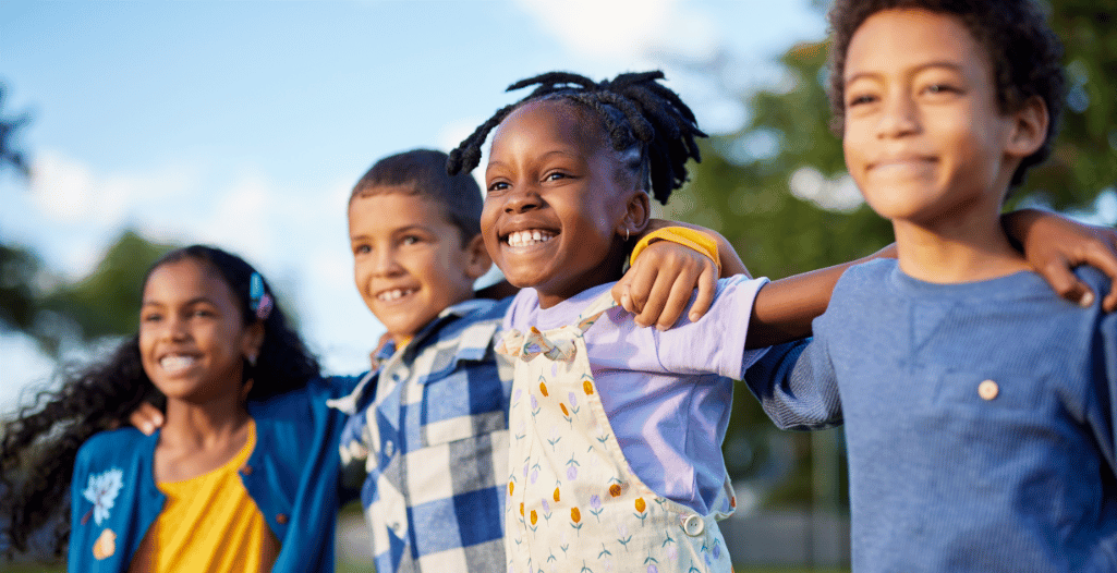 A group of children stand outdoors with their arms around each other’s shoulders, smiling and enjoying a moment of connection and friendship. The scene captures a sense of confidence, inclusivity, and peer bonding. This image represents the Social Pals program at the SAAAC Autism Centre, which supports children in developing meaningful friendships, social communication, and confidence through ABA-guided group experiences.